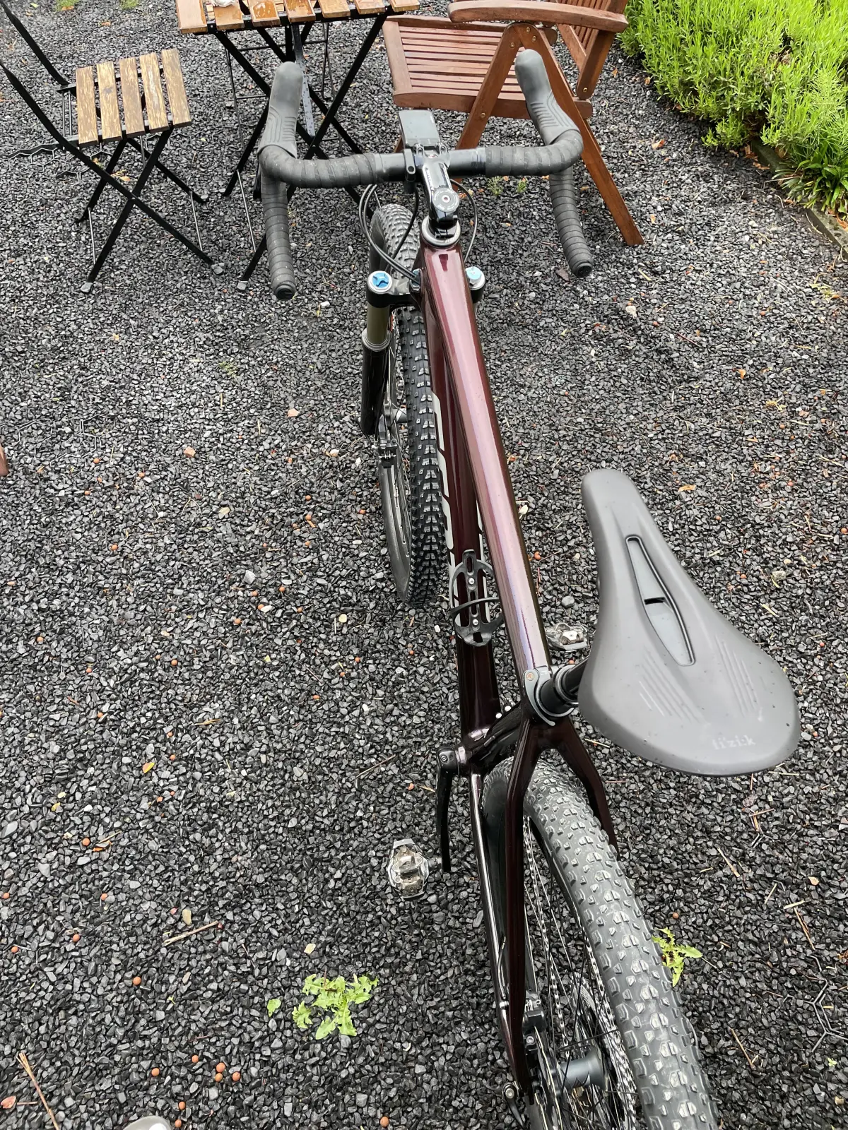 Top tube from a saddle-side angle, showing the cherry red fade over aubergine