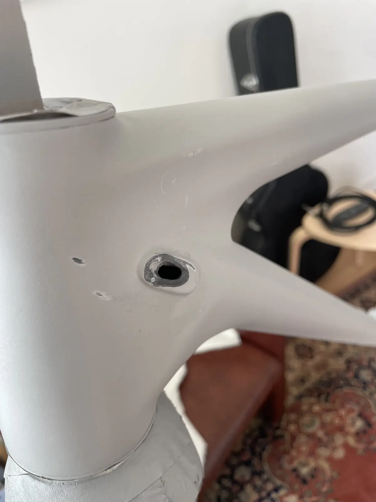 Drilling out a cable routing port on the down-tube