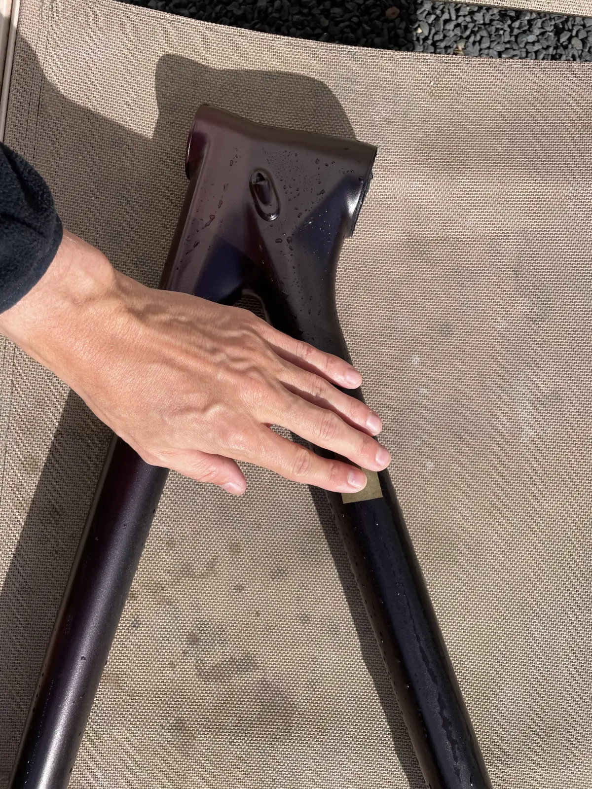 Sanding the aubergine coat with fine grit between layers